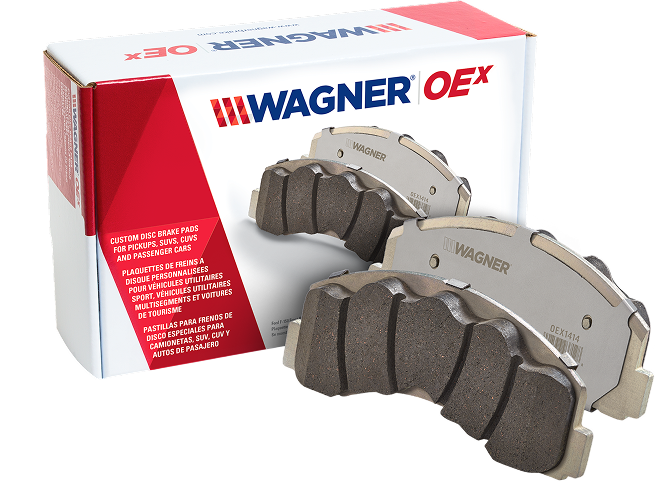 Two Wagner OEX brake pads in front of the box they came in