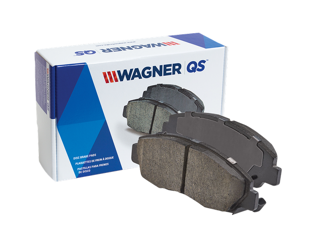 Two Wagner QS brake pads in front of the box they came in